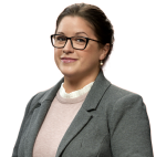 a woman wearing a gray blazer.