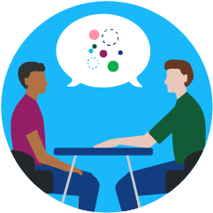 Blue circle with two colleagues sitting at a table looking at each other with a conversation bubble between them.